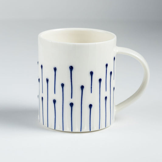 Handmade porcelain tea mug with blue slip-trailed line decoration