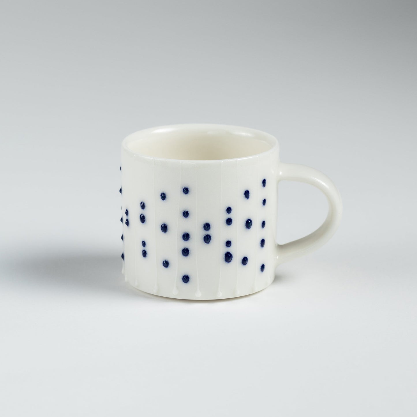 Handmade porcelain espresso cup with blue dotted pattern