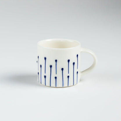 Handmade porcelain espresso cup with blue line decoration