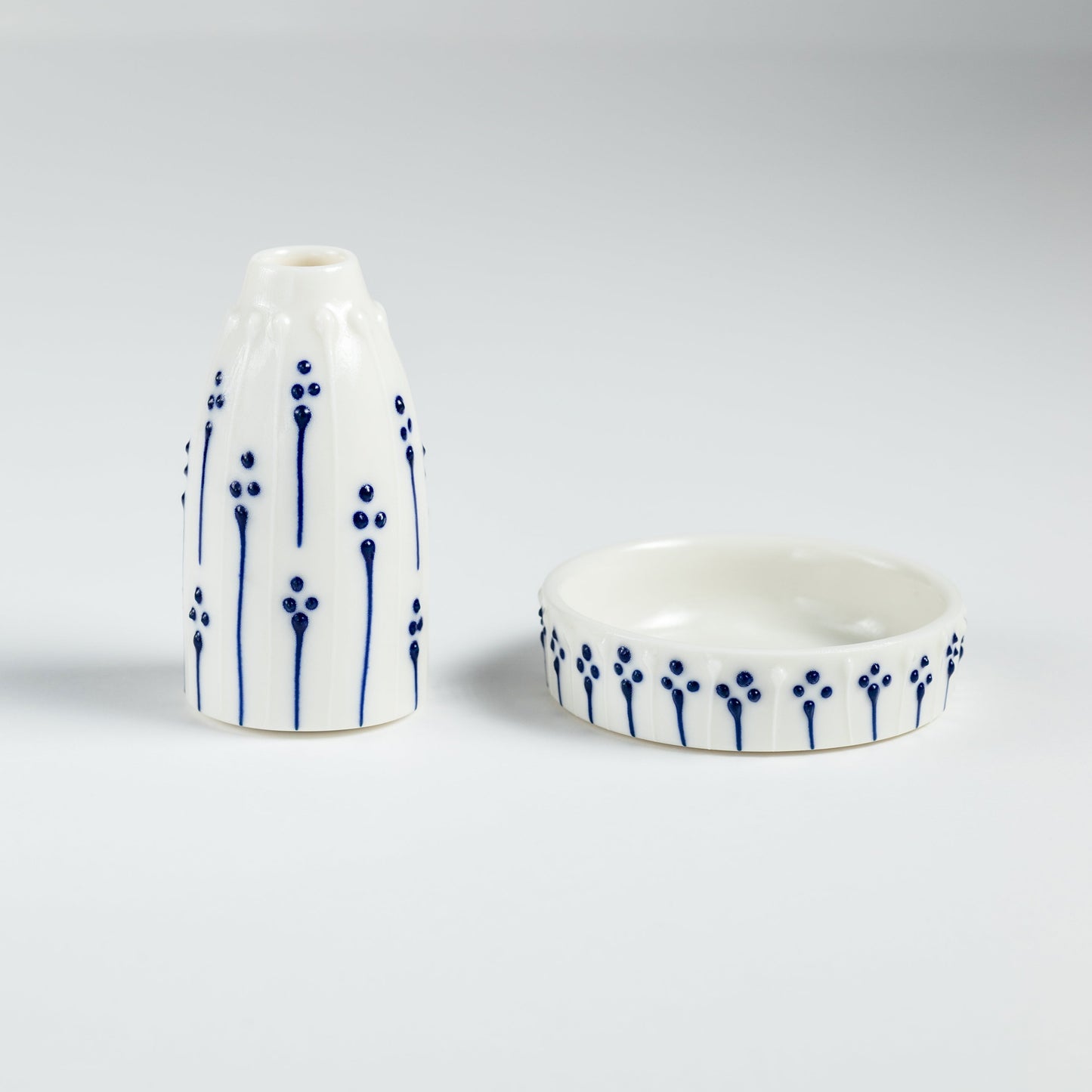 Handmade porcelain mini vase and ring dish gift set with blue slip-trailed floral pattern.