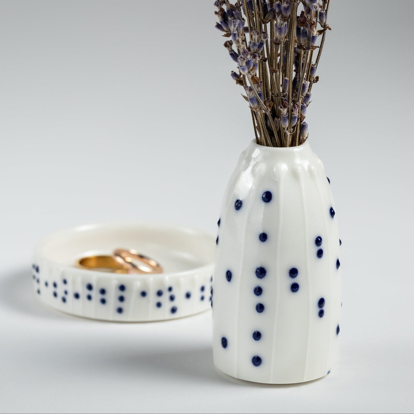 Handmade porcelain mini vase and ring dish gift set with blue slip-trailed dot decoration.