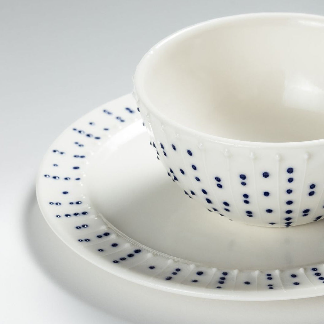 Handmade porcelain side plate with blue dotted pattern styled with breakfast bowl