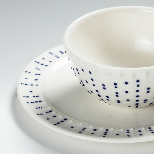 Handmade porcelain side plate with blue dotted pattern styled with breakfast bowl