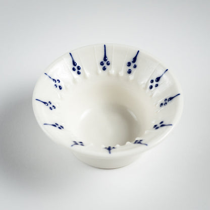 Handmade porcelain tea light holder with flanged rim and blue floral decoration