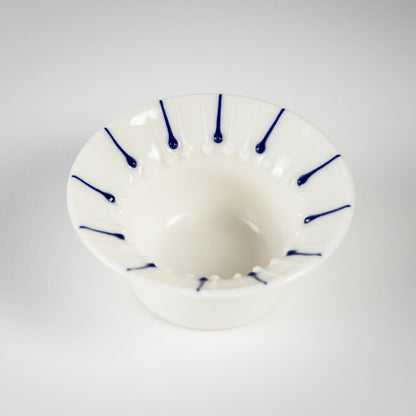 Handmade porcelain tea light holder with flanged rim and blue line decoration