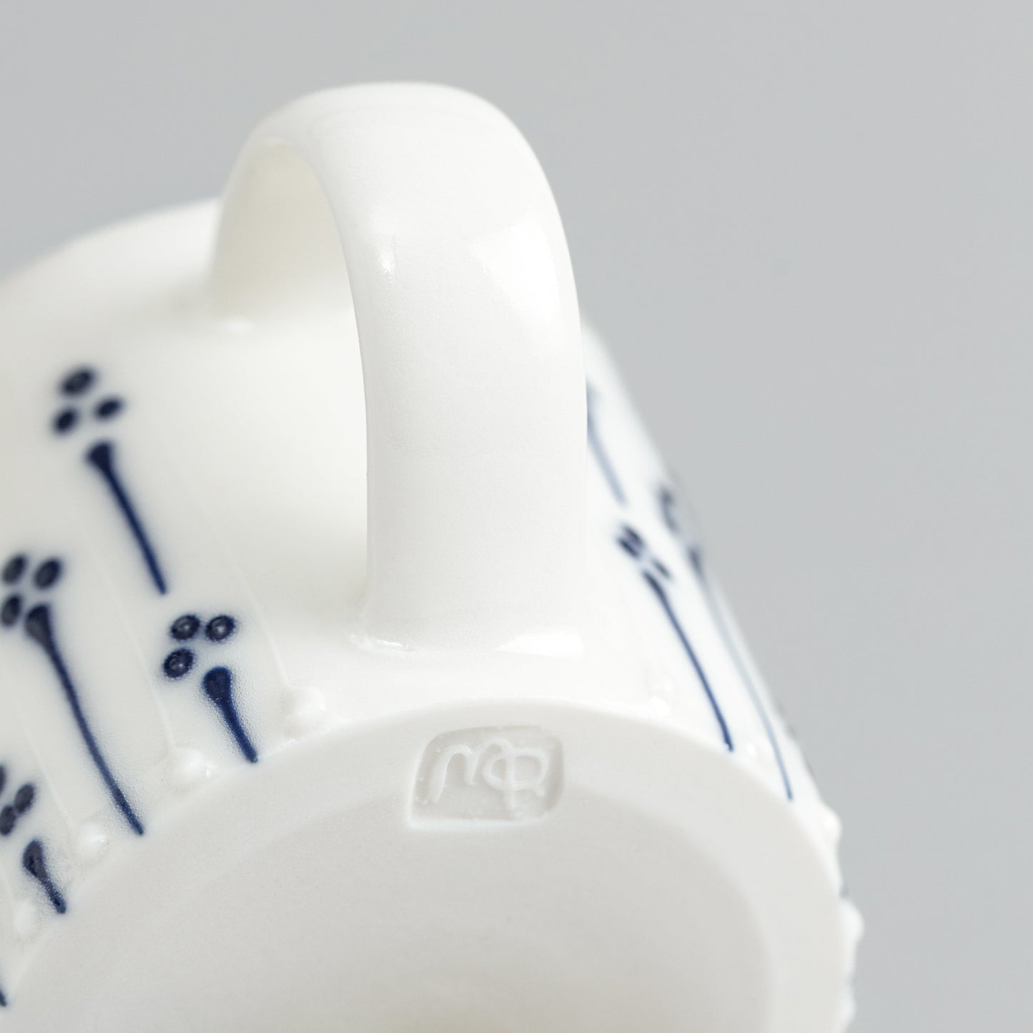 Handmade porcelain espresso cup with maker's mark shown on the base
