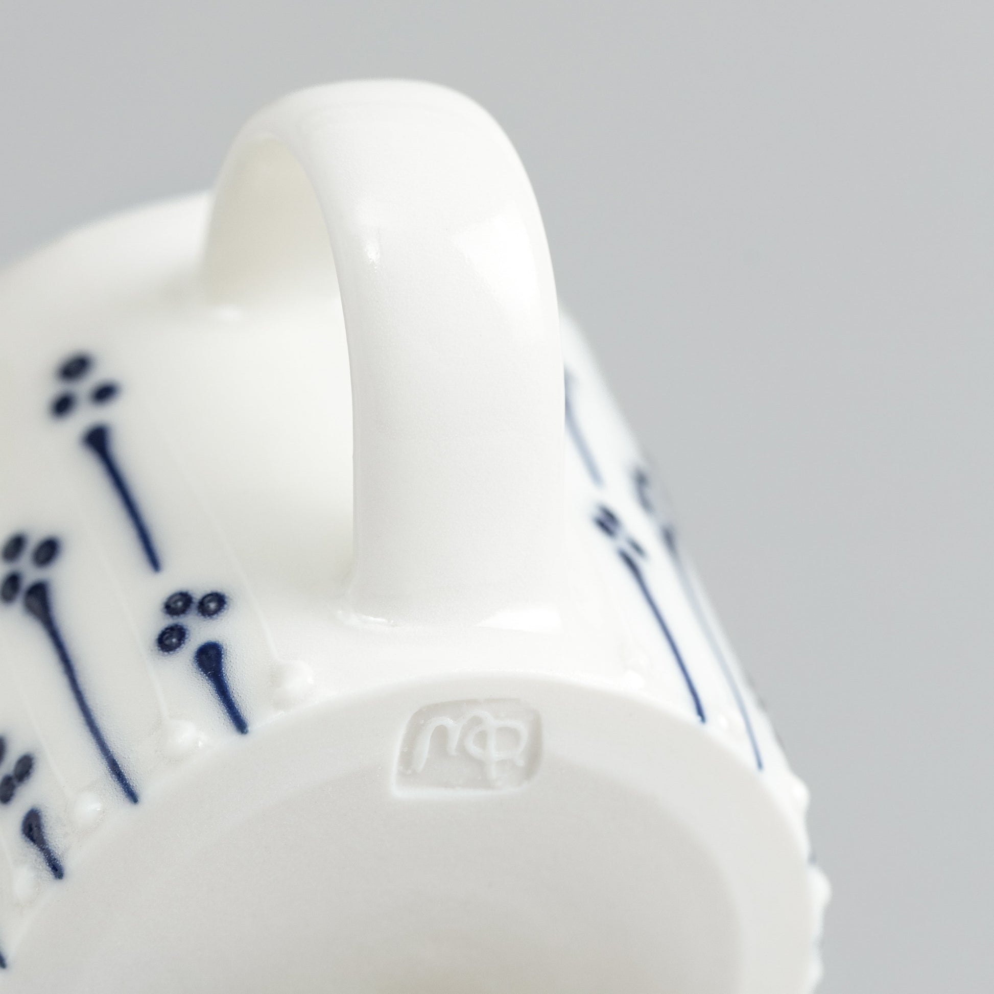 Handmade porcelain espresso cup with maker's mark shown on the base
