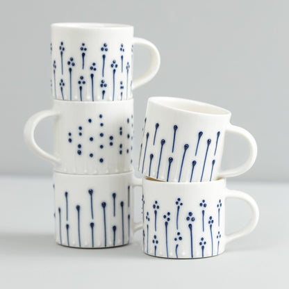 Handmade porcelain espresso cups with blue slip-trailed decoration