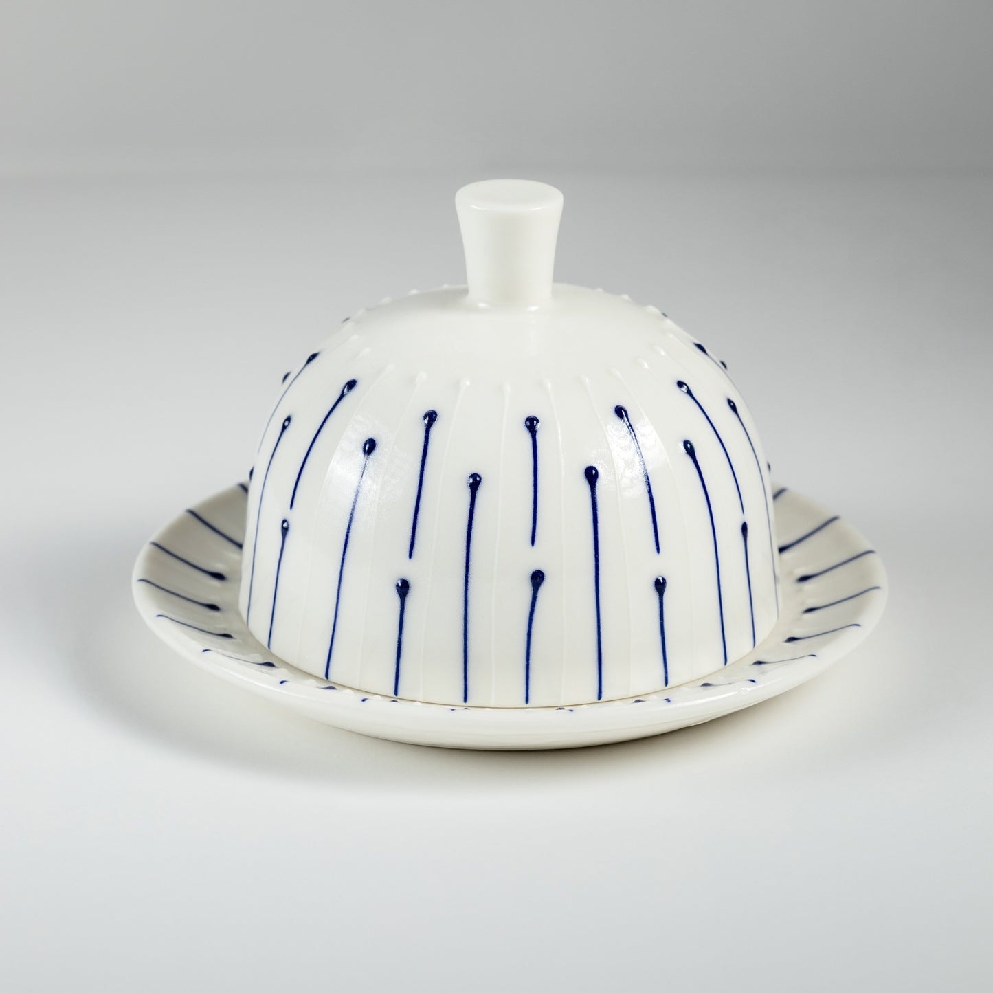 Handmade porcelain butter dish with lid and blue slip-trailed line decoration
