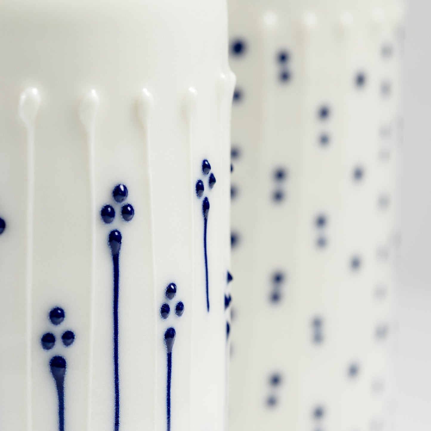 Close-up of raised blue slip-trailed flower decoration on porcelain vase