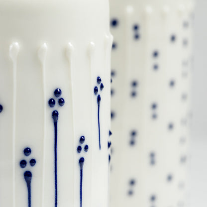 Close-up of raised blue slip-trailed flower decoration on porcelain vase
