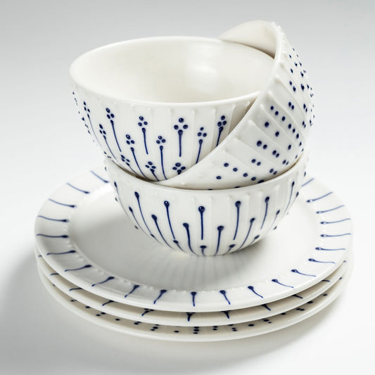 Stacked handmade porcelain breakfast bowls with blue slip-trailed decoration on matching porcelain side plates