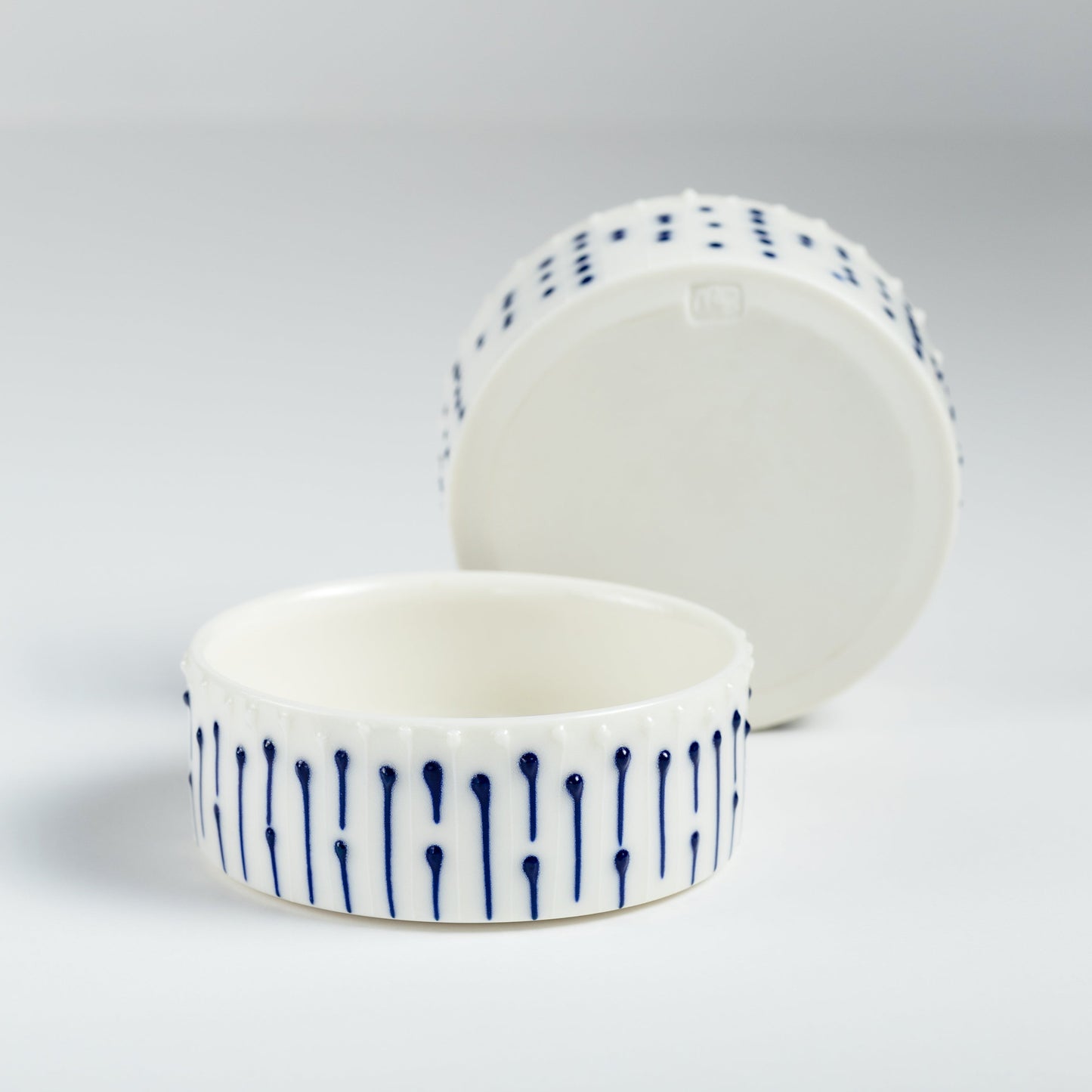 Set of handmade porcelain ramekins with blue slip-trailed decoration