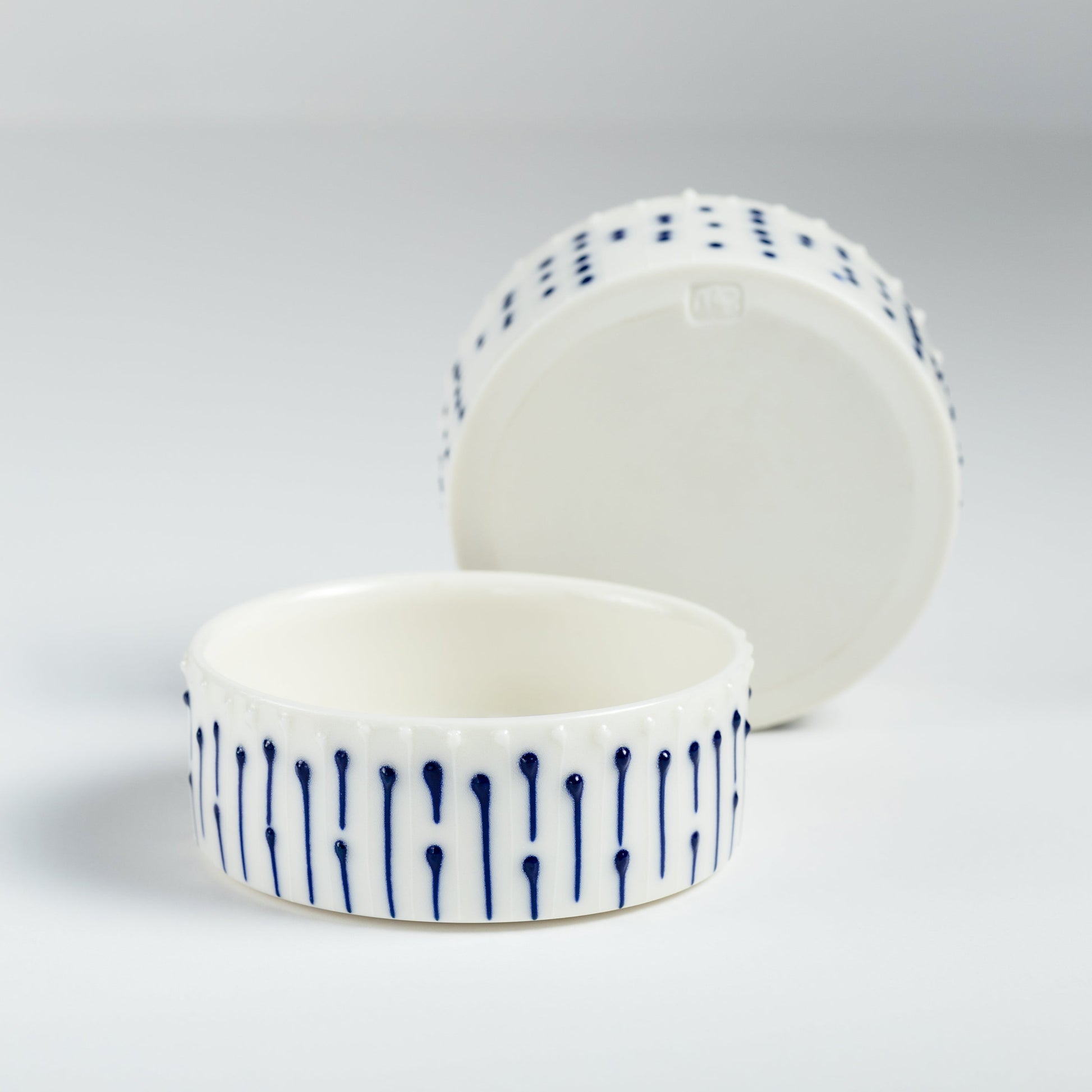 Set of handmade porcelain ramekins with blue slip-trailed decoration