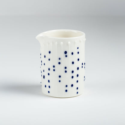 Handmade porcelain milk pourer with blue slip-trailed dot decoration